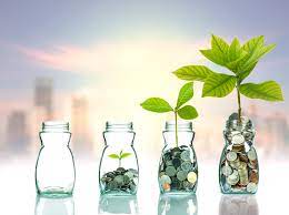 Four glass pots showing how your money can grow. The first glass pot is empty, the second has some money coins and a tiny plant. The third has more money coins and a larger plant. whilst the final pot on the right is full of money coins and has the largest plant.