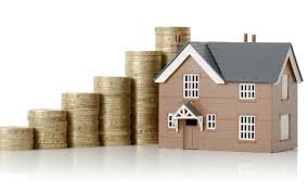 A line of coins stacked up against a house. This shows that property makes your money grow.